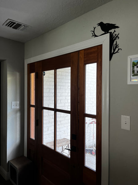 door frame with a metal crow sign