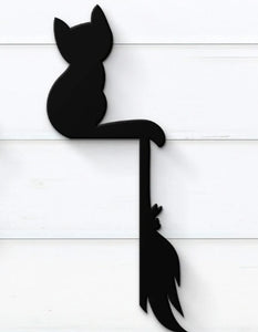 cat and broom door frame sign